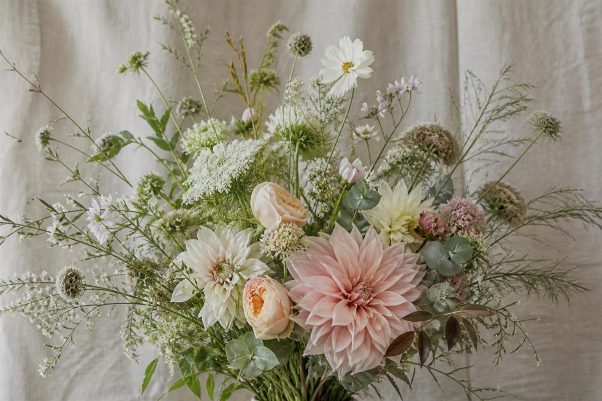 Airy garden-style bouquet with dahlias, grasses, and soft fillers